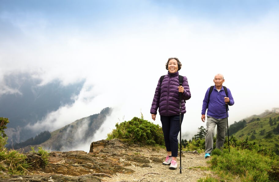 A senior couple hiking on a trail.